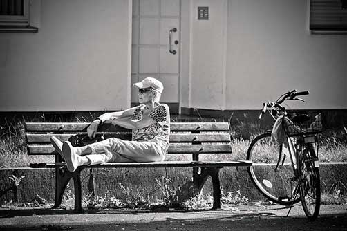Cyclist relaxing on bench